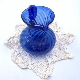 Beautifully handmade blue glass pitcher with handmade doily